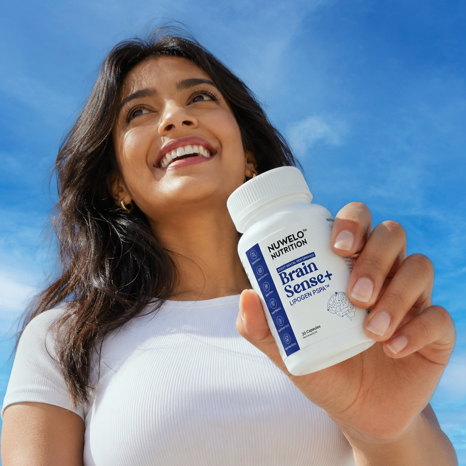 A smiling woman holding up a bottle of Nuwelo Nutrition Brain Sense+ 